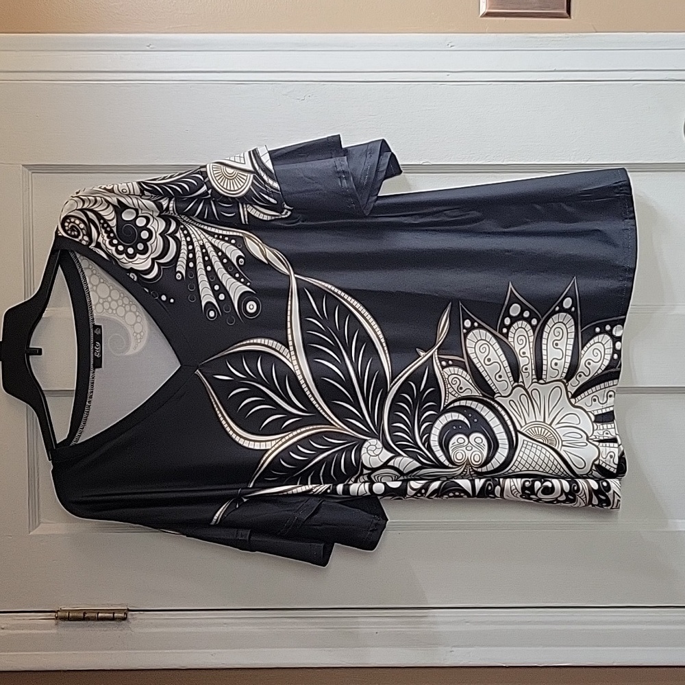 Black, tan, and white floral Tunis with ruffled sleeves